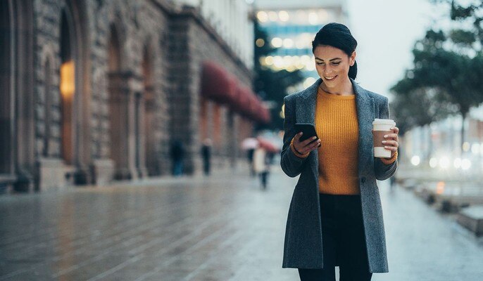 Woman controlling her smat equipment from her mobile phone