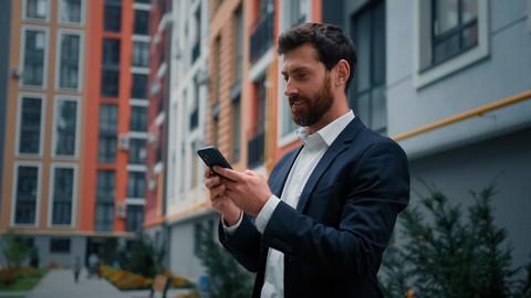 business man in the street with his smartphone